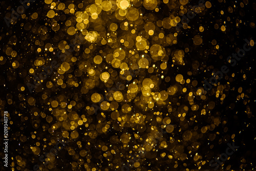 Blurred photo with golden dots visible glittering, shining brightly look and feel luxurious