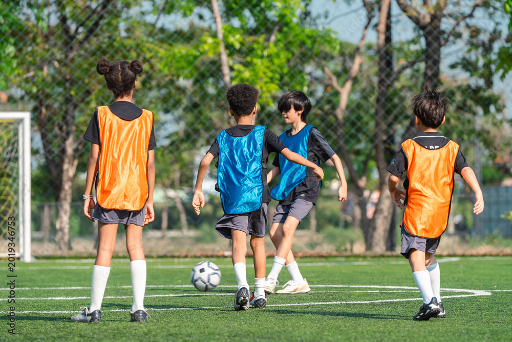 Fototapeta premium World cup concept with soccer or football player, children soccer practice on outdoor field, youth sport teamwork and training
