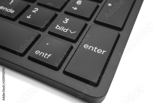 Schilderij op canvas Close-up view of a black computer keyboard showing the enter key and adjacent ke