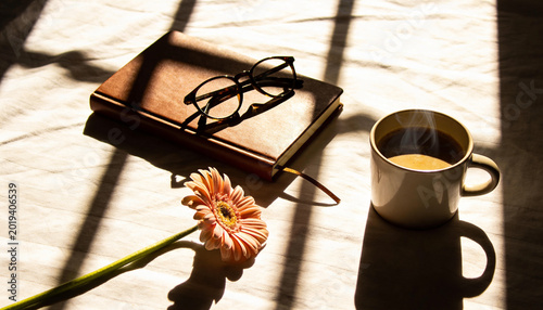 Flat lay of hands journaling in notebook by window with morning coffee