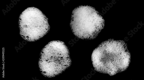 Bild auf Leinwand White soap foam bubbles isolated on black background