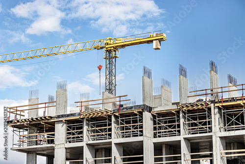 Construction crane over unfinished building structure