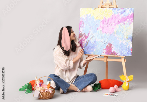 Happy female artist in bunn...