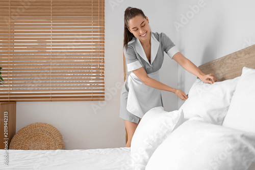 Young chambermaid making be...