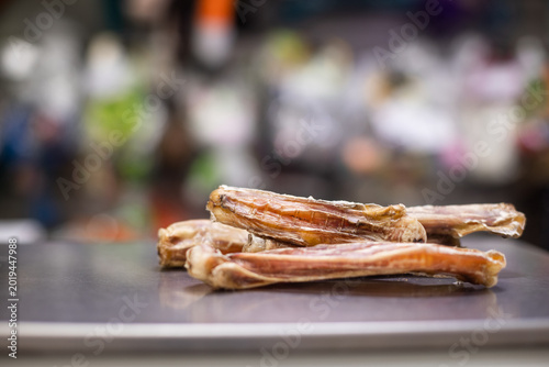 Few dried animal chews laid out in pet store. Chew, treat, pet food, pet store, display scene