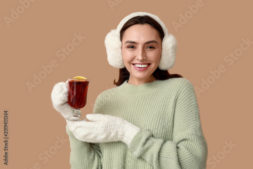 Happy young woman in warm m...
