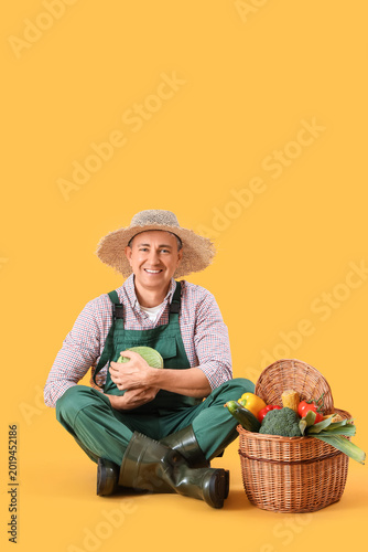 Mature farmer with basket o...