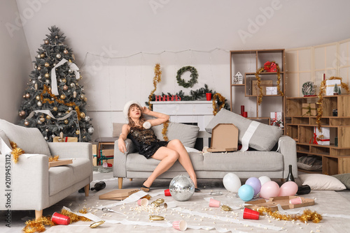 Drunk young woman on sofa i...