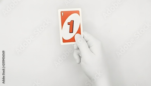 Artificial Hand Holding a Red UNO number one Card Against a white Background. Uno card isolated on white background