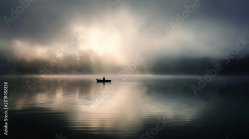 trimaran. A small boat silhouette on a misty lake at dawn with soft light and calm water. travel magazines, destination branding, designed for travel destination branding, inspires travel planning.