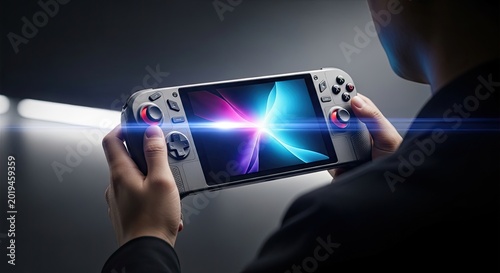 Man holding a portable handheld gaming console in dark setting