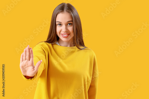 Young woman showing hand on...