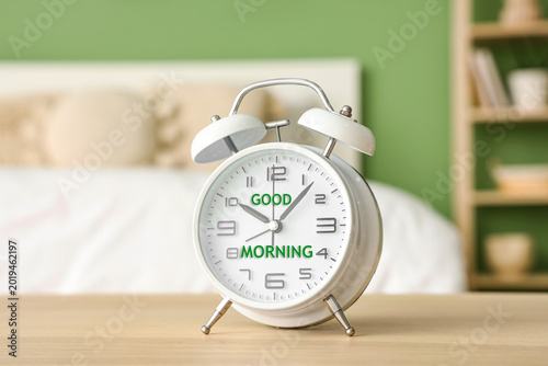 Alarm clock on table in bed...