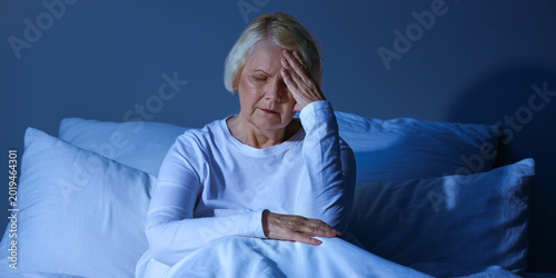 Fotografie Senior woman suffering from sleep deprivation in bedroom