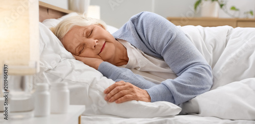 Fotografie Senior woman sleeping in bedroom
