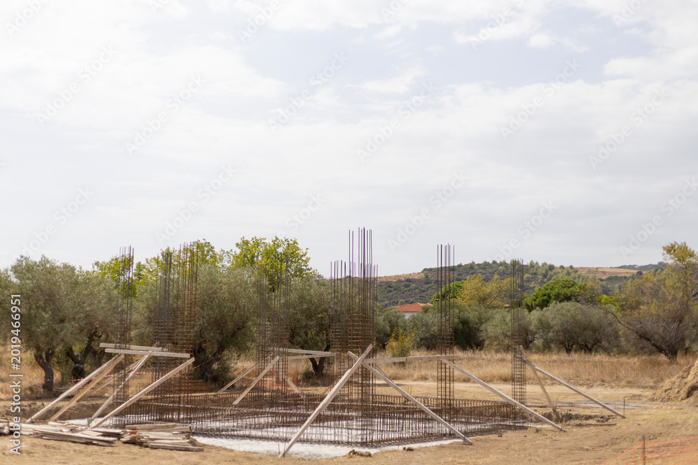 Fototapeta premium Building Foundation Under Construction with Rebar Steel and Wooden Supports