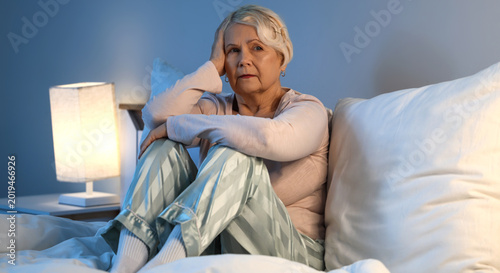 Obraz na plátně Senior woman suffering from sleep deprivation in bedroom
