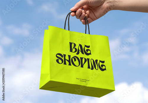 Hand Holding Paper Shopping Bag Mockup with Sky Background