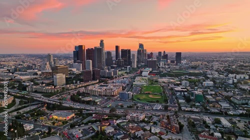 Los Angeles skyline at sunset. LA cityscape under sunset. Aerial shot over Los Angeles. Sunset city view of LA. Downtown Los Angeles from drone. Los Angeles skyline at dusk.