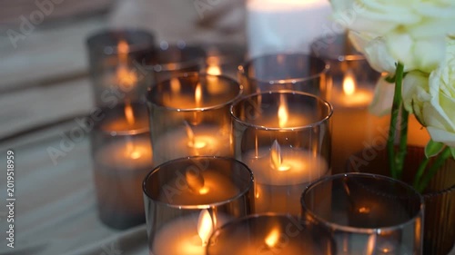Close-up of artificial LED candles and white roses. Wedding decorations
