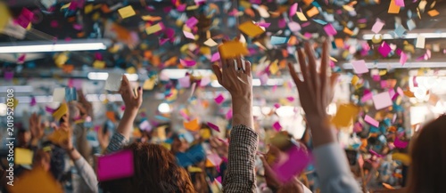 Cinematic photograph of diverse employees celebrating together at a corporate event, with colorful confetti filling the air and a lively atmosphere