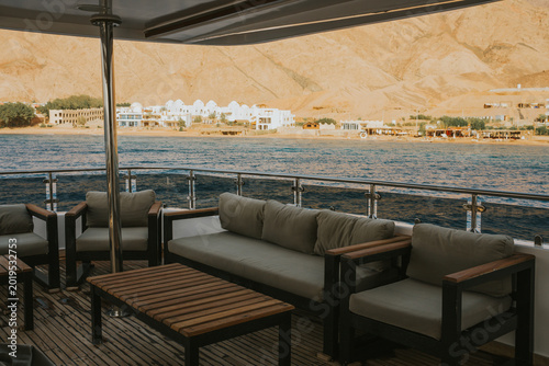 Konstfotografi Yacht sundeck offering a comfortable seating area overlooking a tranquil sea and