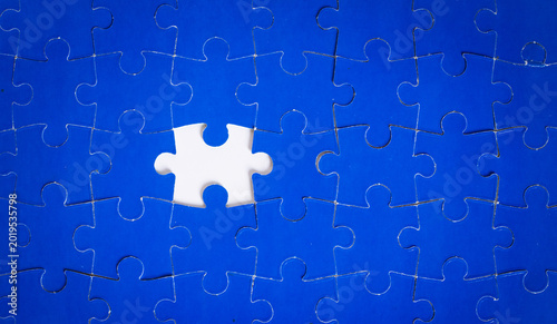 Blue puzzle nearly complete, one piece missing
