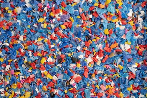 Photos Plastic colorful pieces recycling shredded for industrial use.