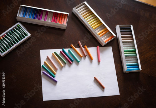 Фотография Set of colored pencils laid out on a white background