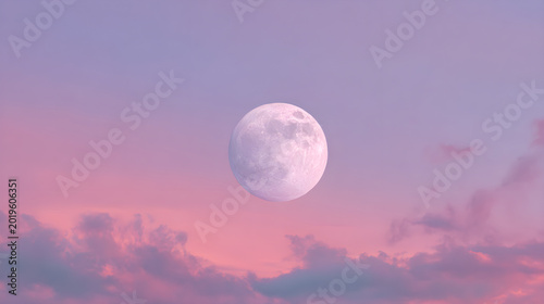 A luminous full moon glows brightly in the center of a soft pastel lavender and pink gradient sky filled with gentle drifting clouds during a serene twilight