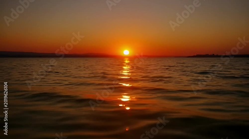 Sunset over calm sea water.