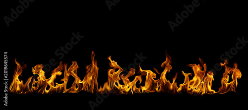 Photography Realistic blazing fire flames isolated on black background, dramatic burning border with glowing heat and inferno effect, ideal for overlays, danger, wildfire, energy and dark design projects