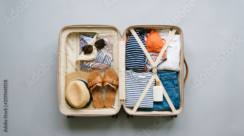 Minimal travel suitcase with folded clothes