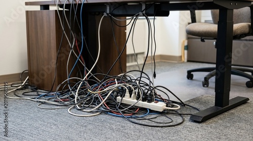 Messy Tangled Computer Cables Under Office Desk.