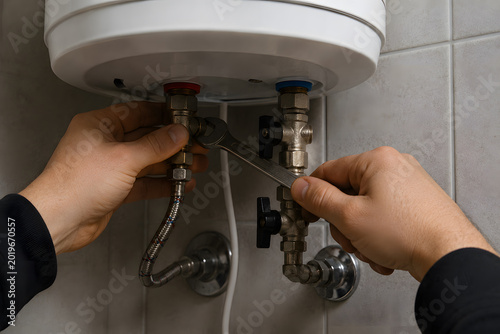 Professional plumber connecting a water hose to a residential water heater during plumbing installation. Modern boiler system maintenance and repair work in a home utility room. AI-generated image.
