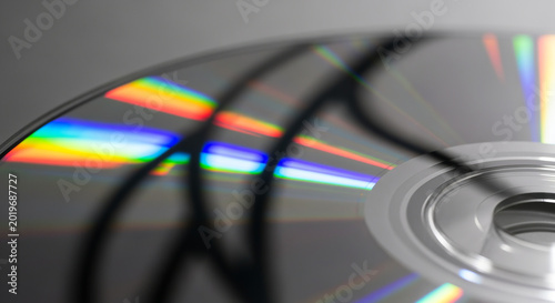 holographic rainbow reflections dancing on a spinning CD disc, dynamic light streaks and prism effects 