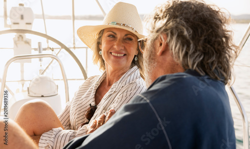 Konstfotografi Senior couple enjoying sailing vacation on boat at sunset