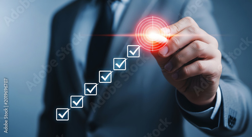 Man in gray suit points to glowing red target with checkmarks pointing hand
