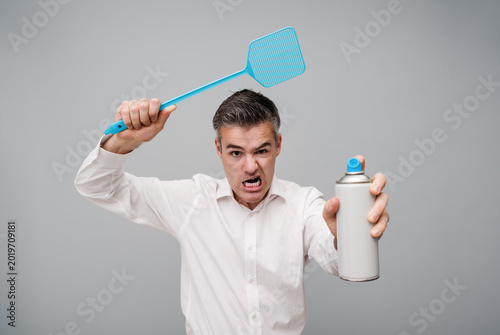 Angry man killing insects