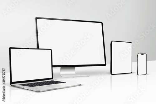 A mockup of computer screen, laptop, tablet, smartphone on a table