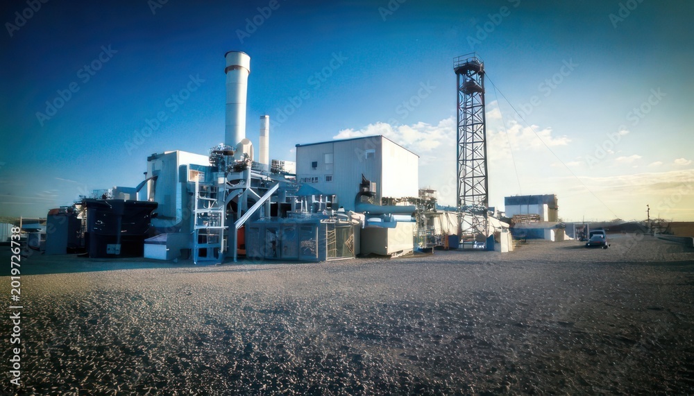 Fototapeta premium Industrial Power Plant Complex Under a Clear Blue Sky.