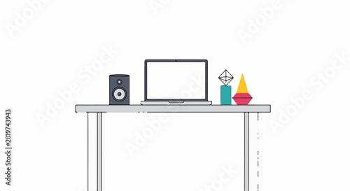 A minimalist desk setup with a laptop, speaker, and geometric decor