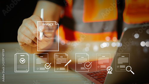 Construction engineer using a digital tablet for invoice management and document processing. Online billing system for industrial business, smart logistics, and financial accounting technology.