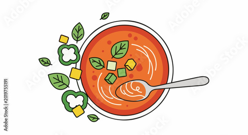 Top view of a bowl of gazpacho with spoon and ingredients