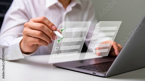 Online Survey Completion: A person's hand guides a stylus, digitally interacting with a virtual survey form displayed on a laptop screen. Demonstrating ease and efficiency in gathering insights