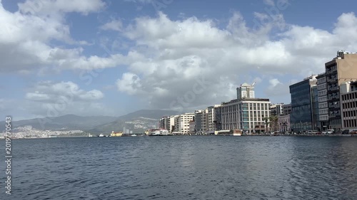 Wide Angle Sea View of Izmir Pasaport Waterfront Promenade City Skyline and Distant Mountains under Cloudy Sky Footage