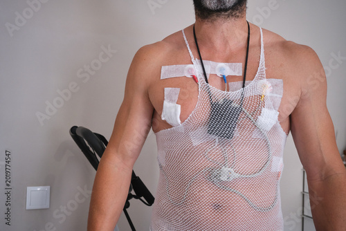 Athletic man with a Holter monitor for heart examination