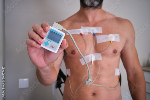 Man holding holter monitor for heart examination