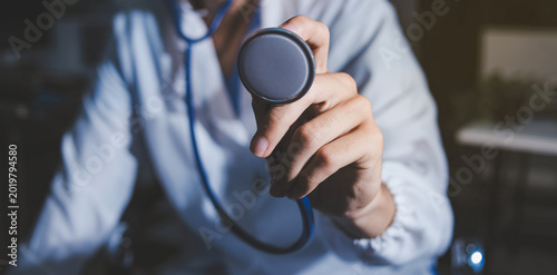 Homecare nursing service and elderly people cardiology healthcare. Close up of young hispanic female doctor nurse check mature caucasian man patient heartbeat using stethoscope during visit