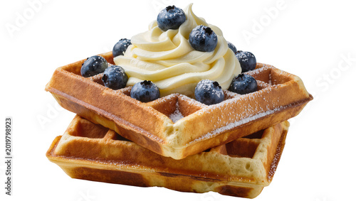 Obraz na płótnie Golden brown waffles topped with creamy frosting and fresh blueberries, isolated